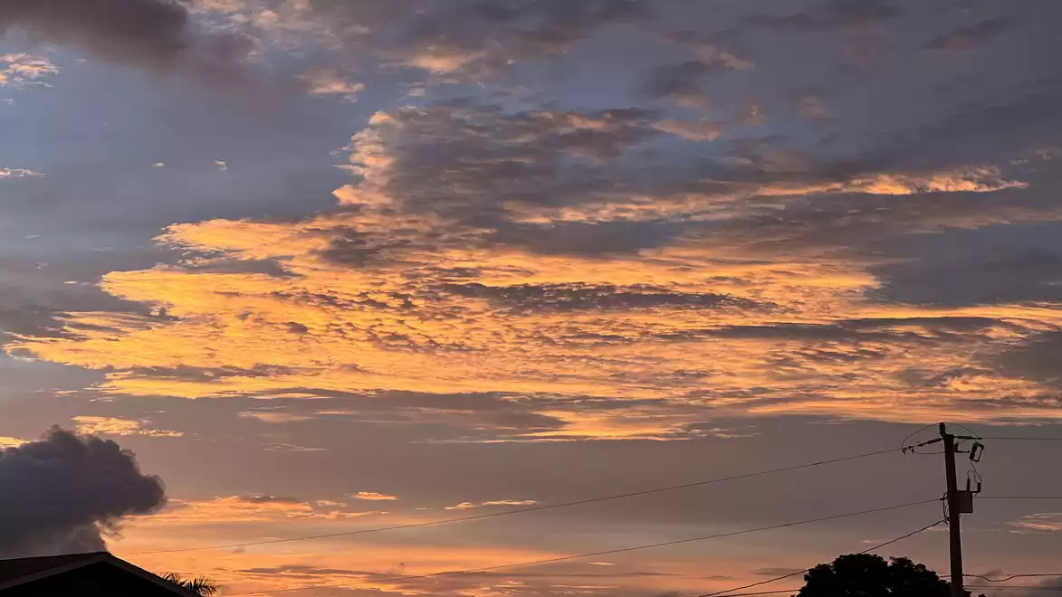 A beautiful sunset with orange and purple clouds in the sky.