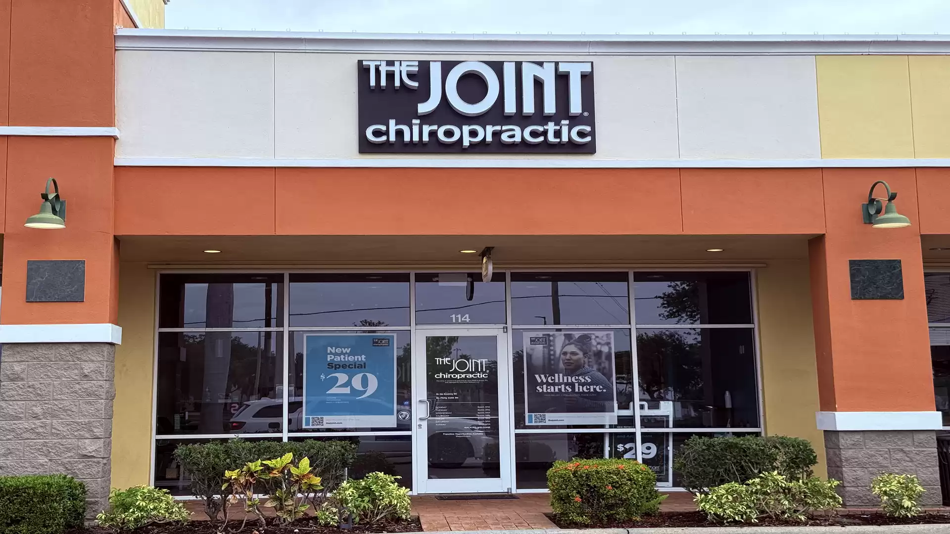 Exterior view of a chiropractic clinic named 'The Joint' in a modern commercial building.