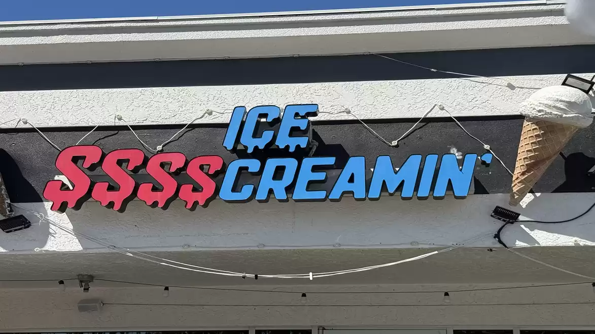 Sign reading 'Ice Screamin'' with an ice cream cone design decoration.