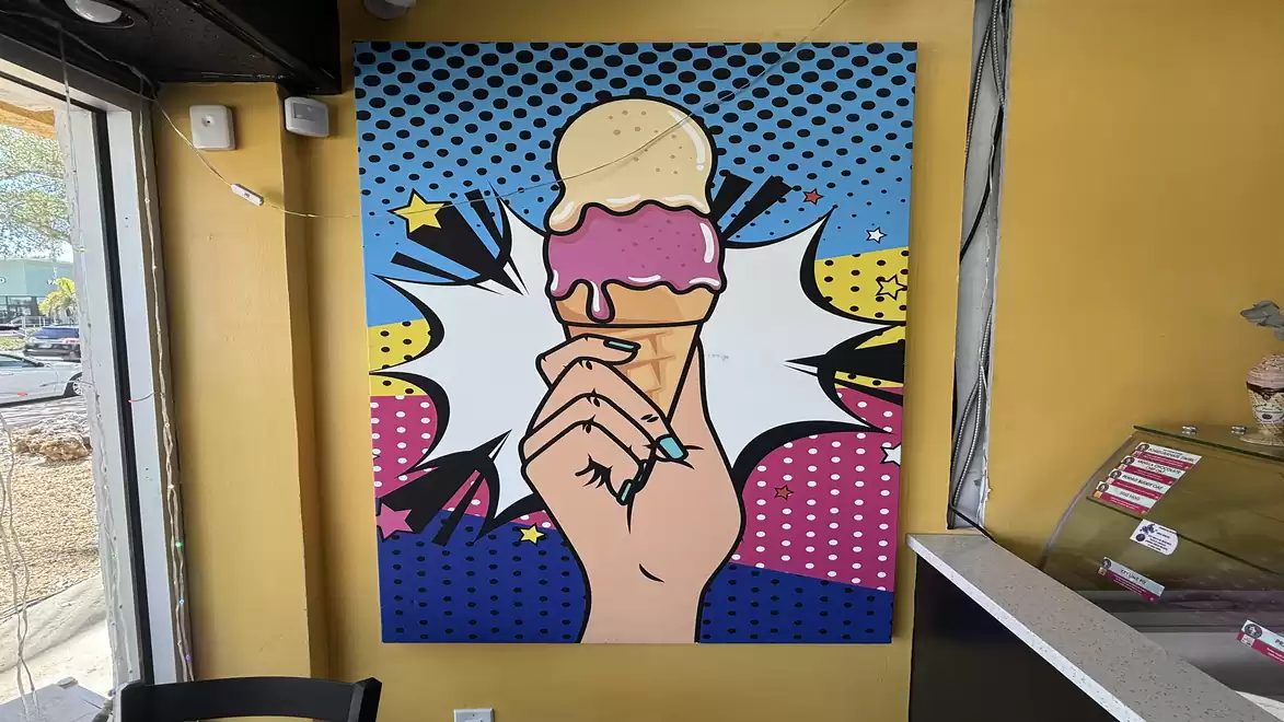Pop art painting of a hand holding an ice cream cone in a modern ice cream shop.