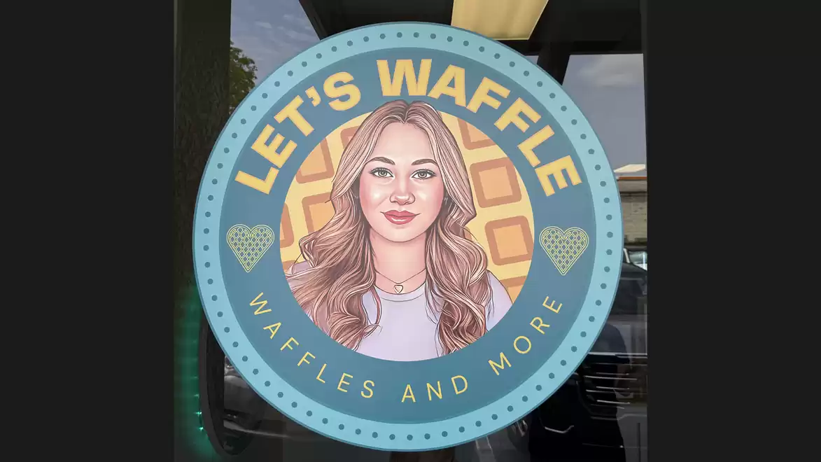 A round logo of a waffle shop with the text 'Let's Waffle' and 'Waffles and More'. The logo features a portrait of a smiling woman with long hair.