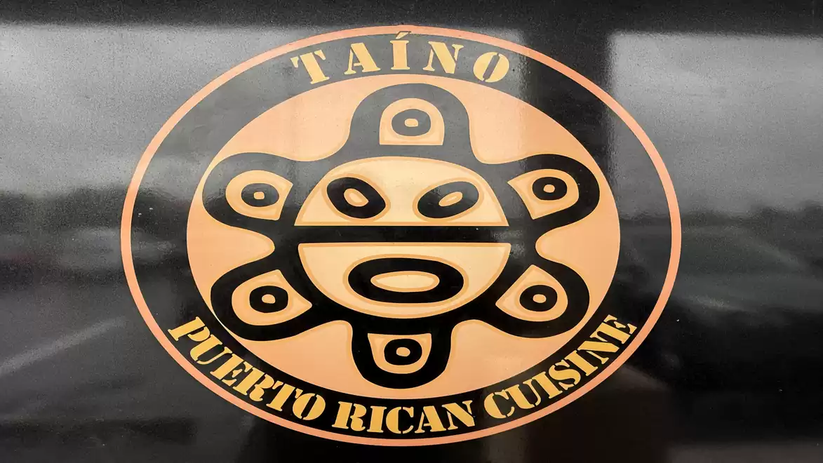 A logo with the text Táino Puerto Rican Cuisine features a stylized face pattern.