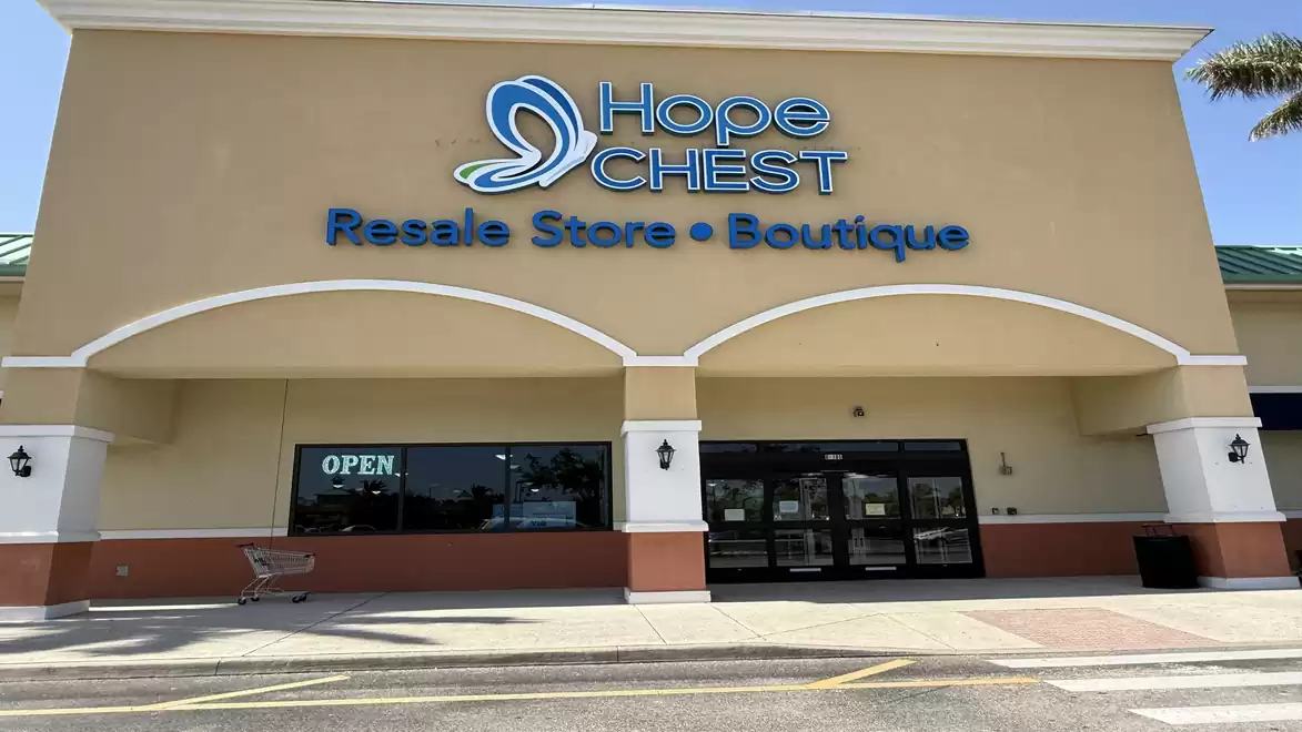 Exterior view of a resale store named Hope CHEST. Boutique shop with open sign.