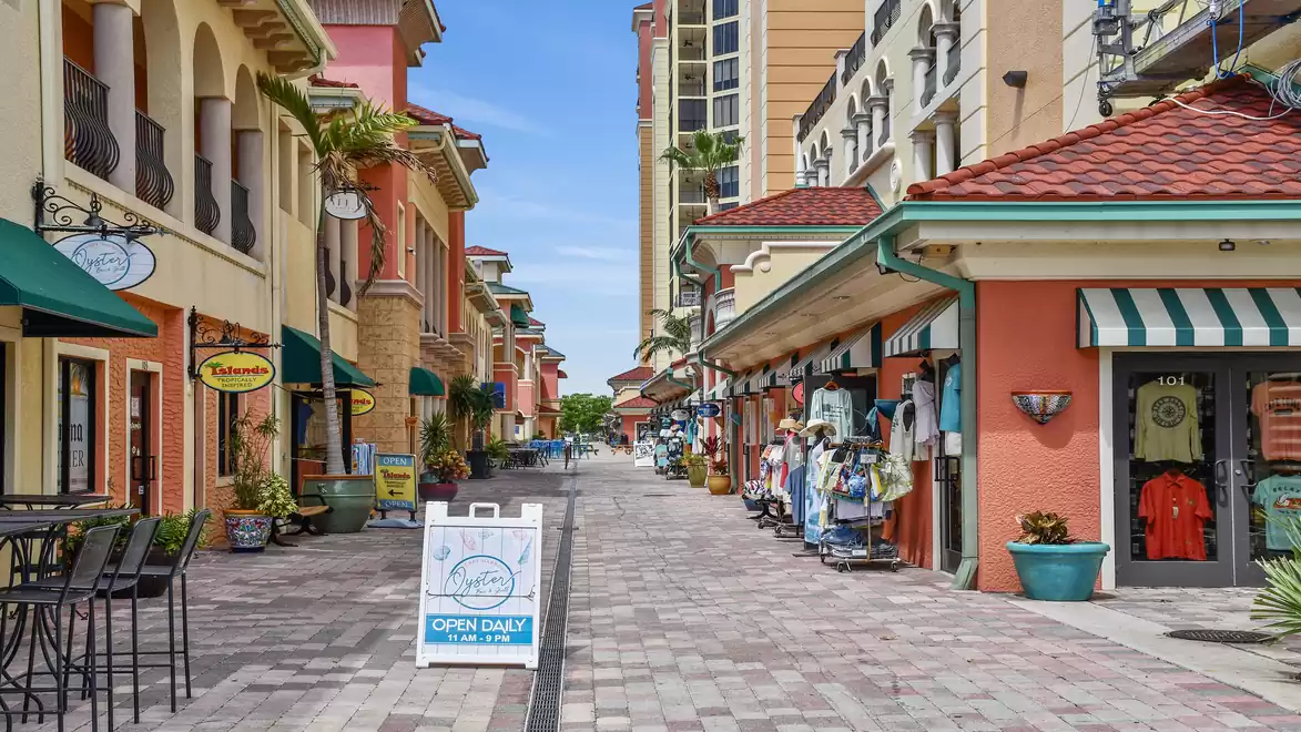A picturesque shopping street with colorful buildings and shops in sunny weather.