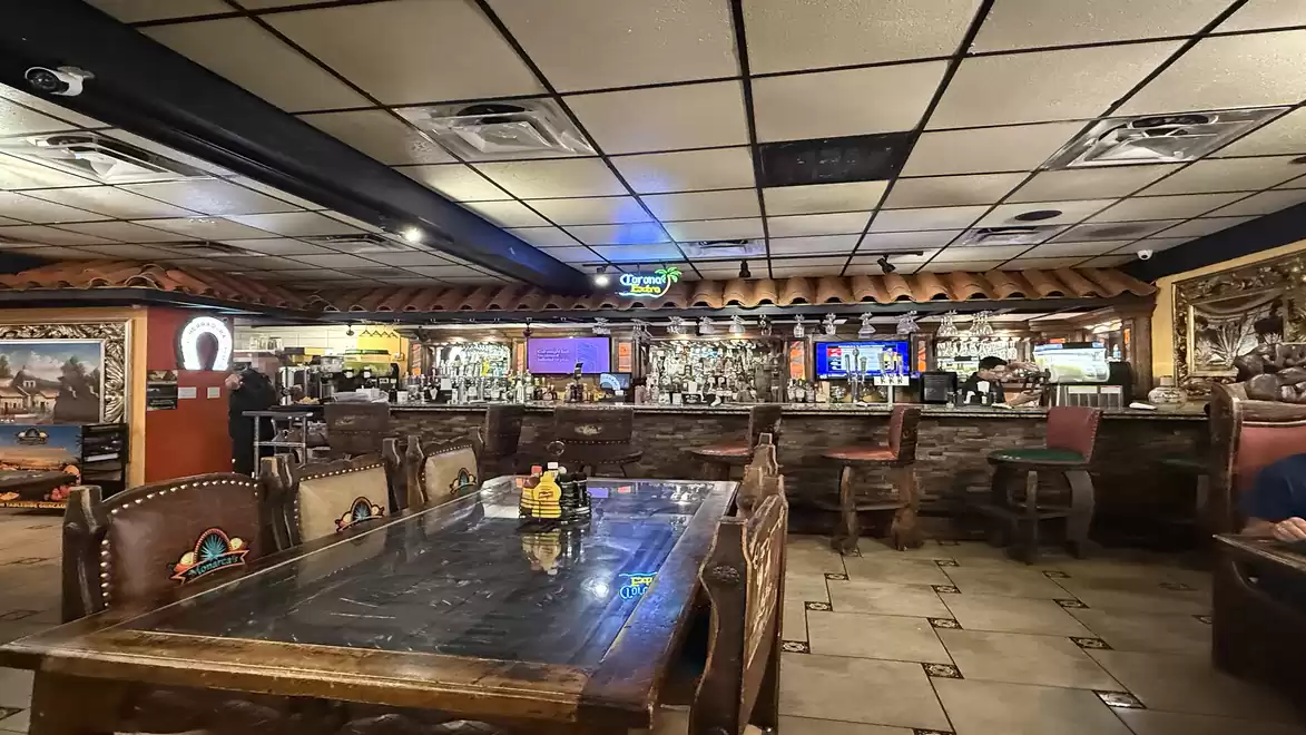 A cozy restaurant with rustic decor, wooden tables, and decorative elements on the walls, perfect for a relaxed meal.