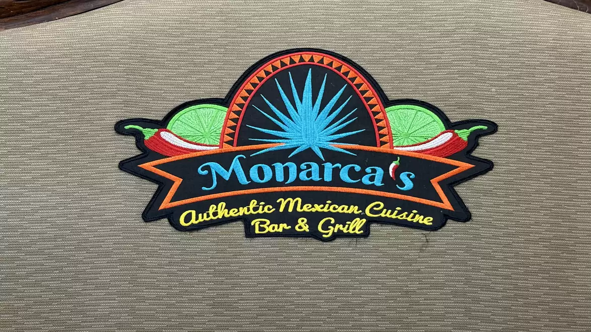 Logo of Monarca's Bar & Grill with agave plant and limes.
