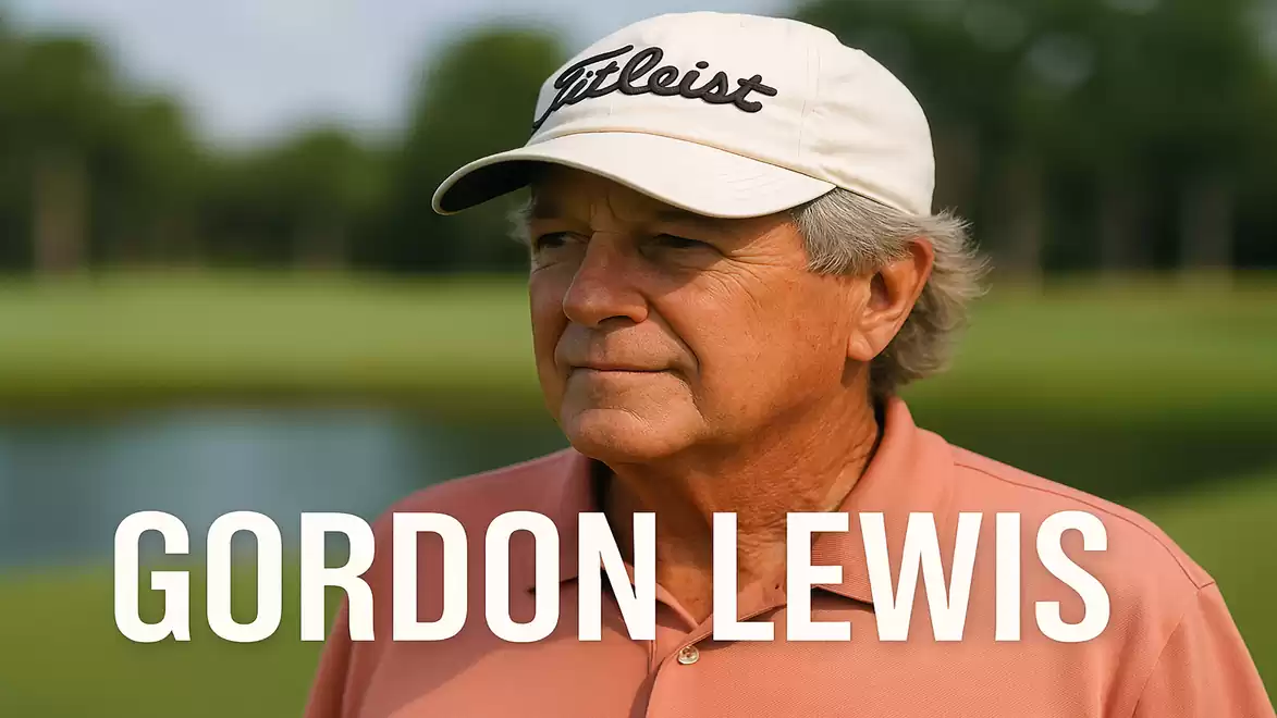 A man wearing a cap stands on a golf course.