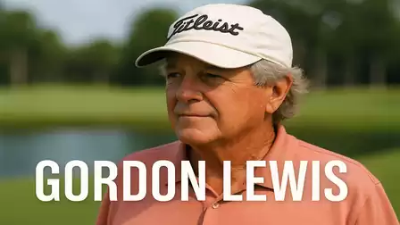 A man wearing a cap stands on a golf course.