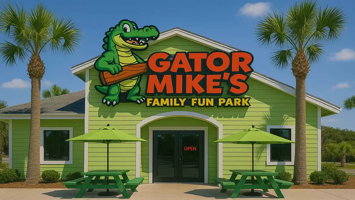 Entrance to Gator Mike's Family Fun Park with a green building and crocodile logo, surrounded by palm trees.