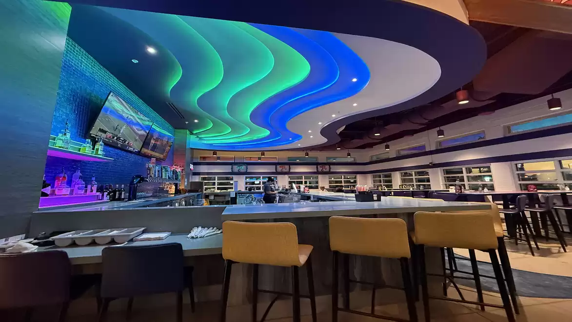 Modern bar with multicolored LED lighting and stylish interior design.