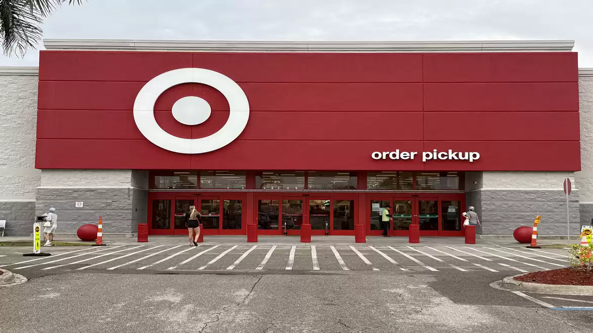 Entrance of a large retail store with a red logo and the text 'order pickup'.
