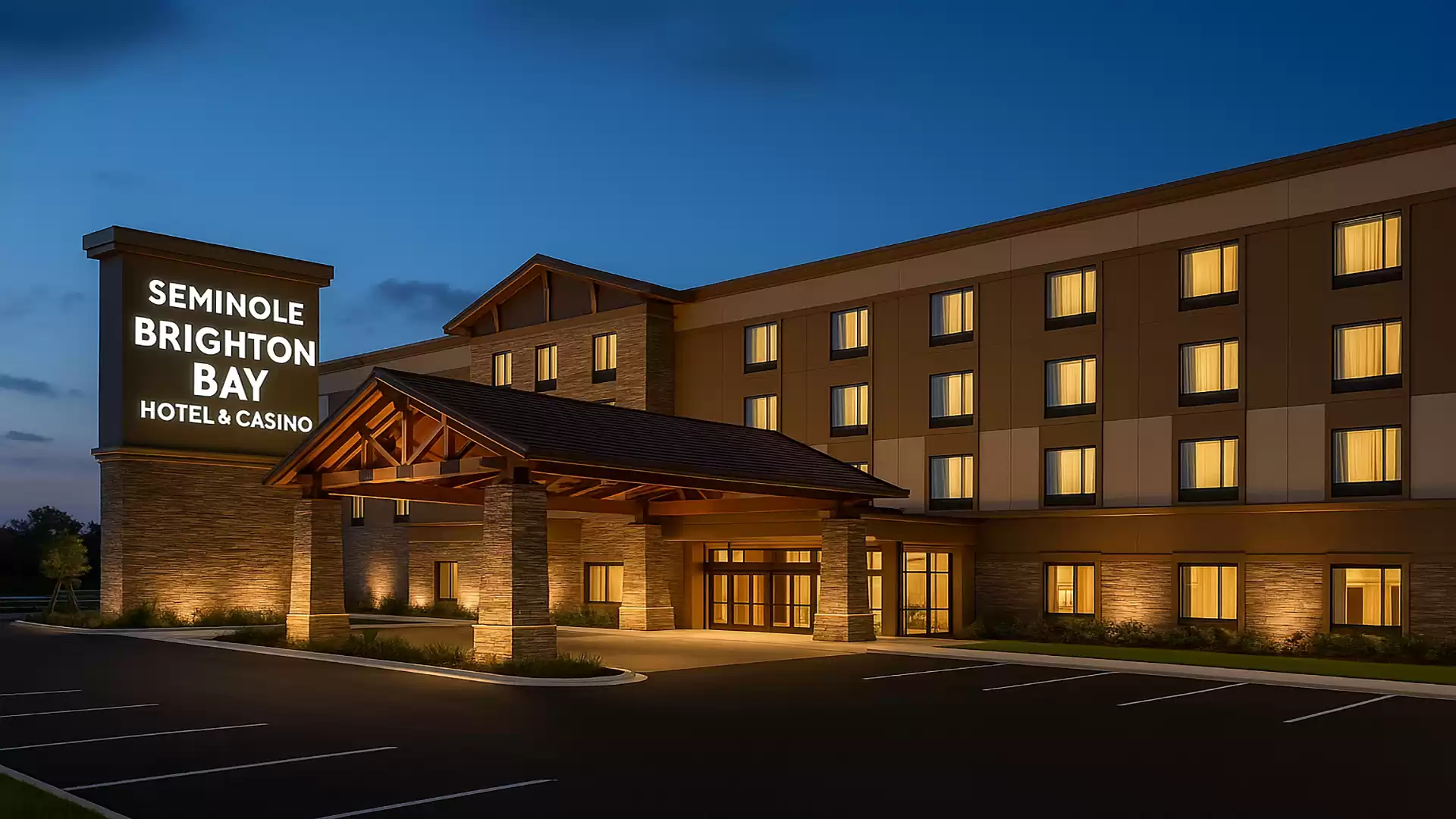 Exterior view of Seminole Brighton Bay Hotel and Casino at night with illuminated windows and entrance.
