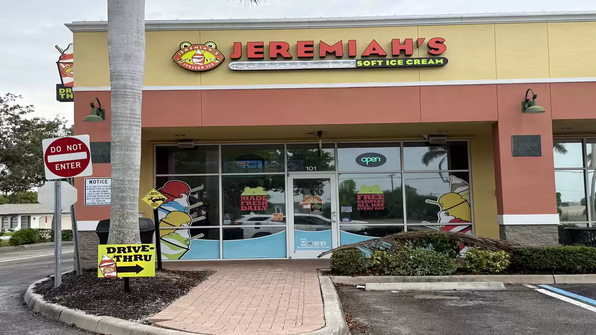 Exterior view of a soft ice cream shop named Jeremiah's. The building is colorfully designed and a drive-thru sign is visible.
