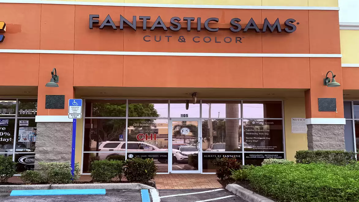 Exterior view of a hair salon named Fantastic Sams Cut & Color with an orange facade.