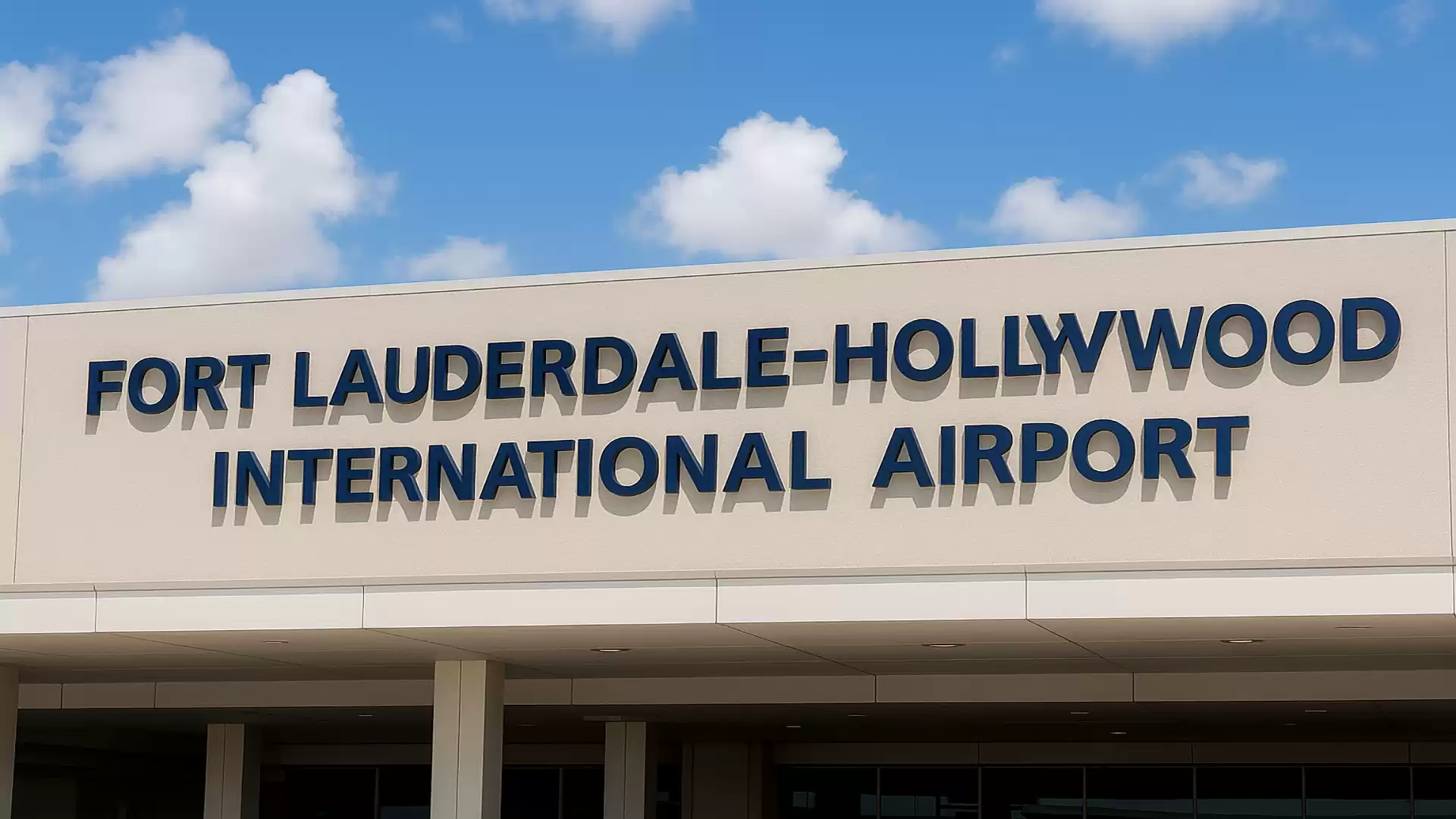 Front view of the entrance to Fort Lauderdale-Hollywood International Airport with blue sky in the background.