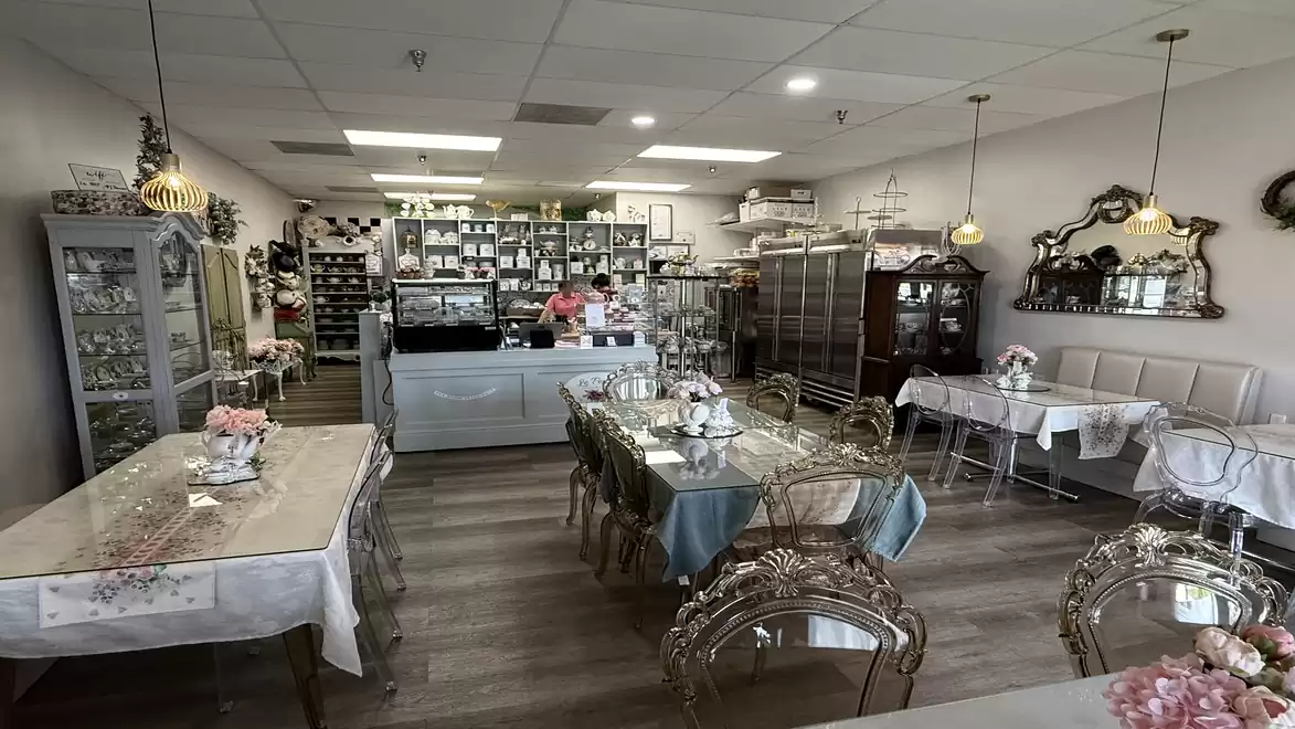 A cozy café with elegant furniture and decorative mirrors, offering a warm and inviting atmosphere.