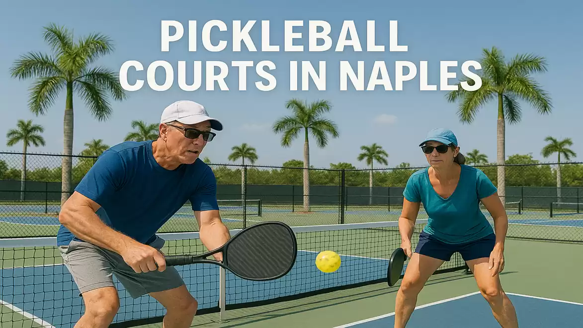 Two people playing pickleball on a court in Naples, surrounded by palm trees.