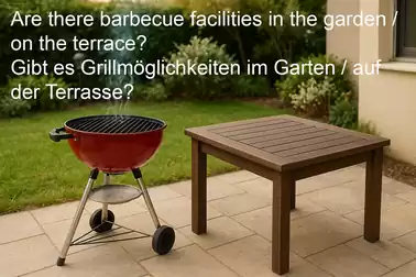 A red charcoal grill next to a wooden table on a terrace, with the question about barbecue facilities in the garden or on the terrace.