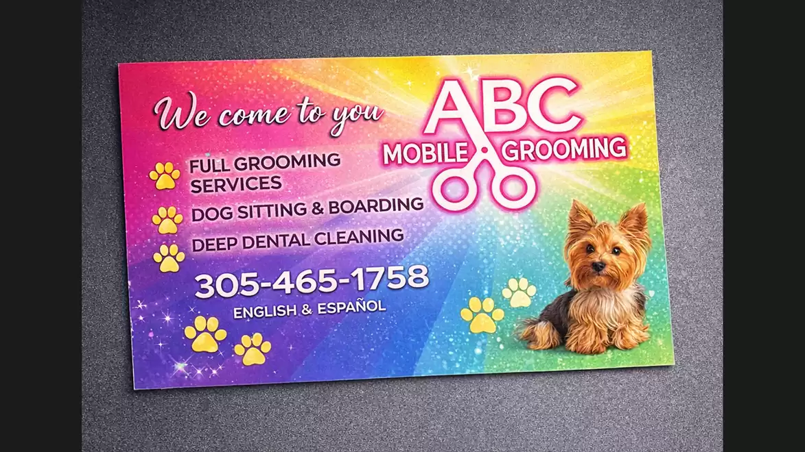 Colorful advertisement card for mobile pet grooming service featuring a Yorkshire Terrier and contact information.