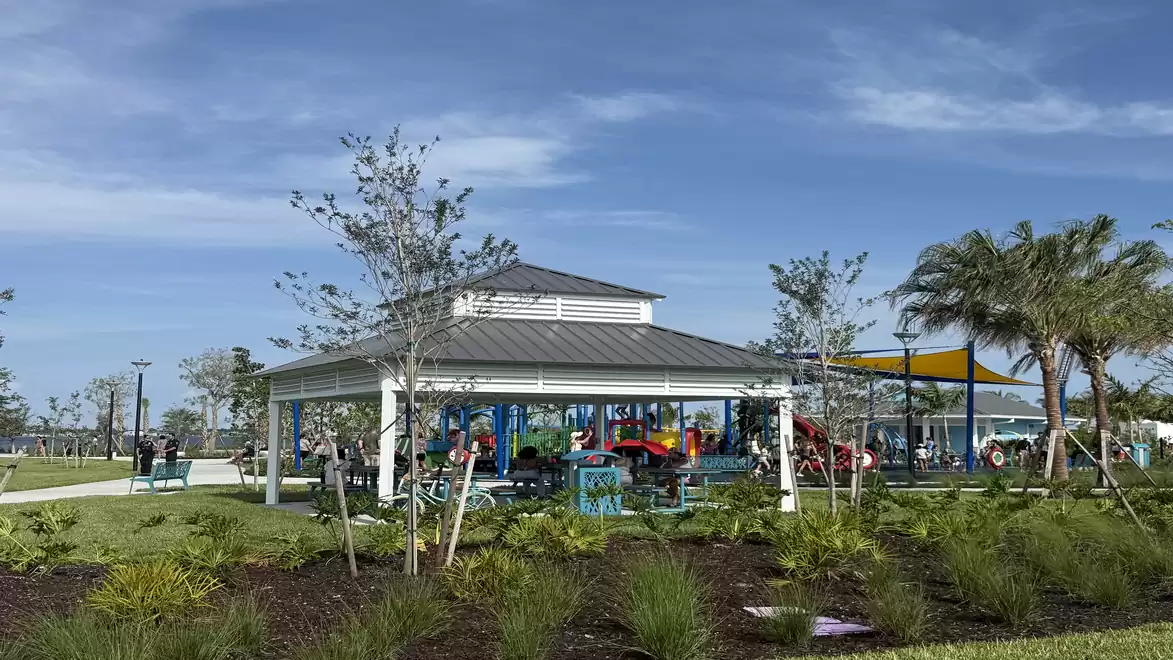 Playground in Jaycee Park, Cape Coral with pavilion and surrounding landscape.