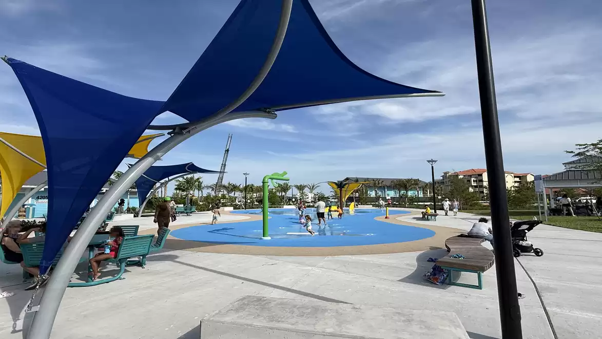 A recreational area in Jaycee Park in Cape Coral with play equipment and sunshades in sunny weather.
