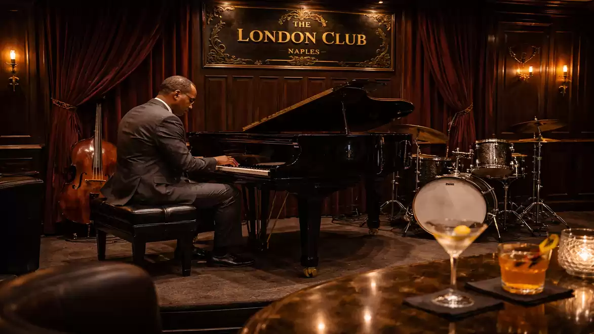 An elegant man plays piano in a stylishly furnished club with drums and double bass in the background, surrounded by dark wood decor and soft lighting.