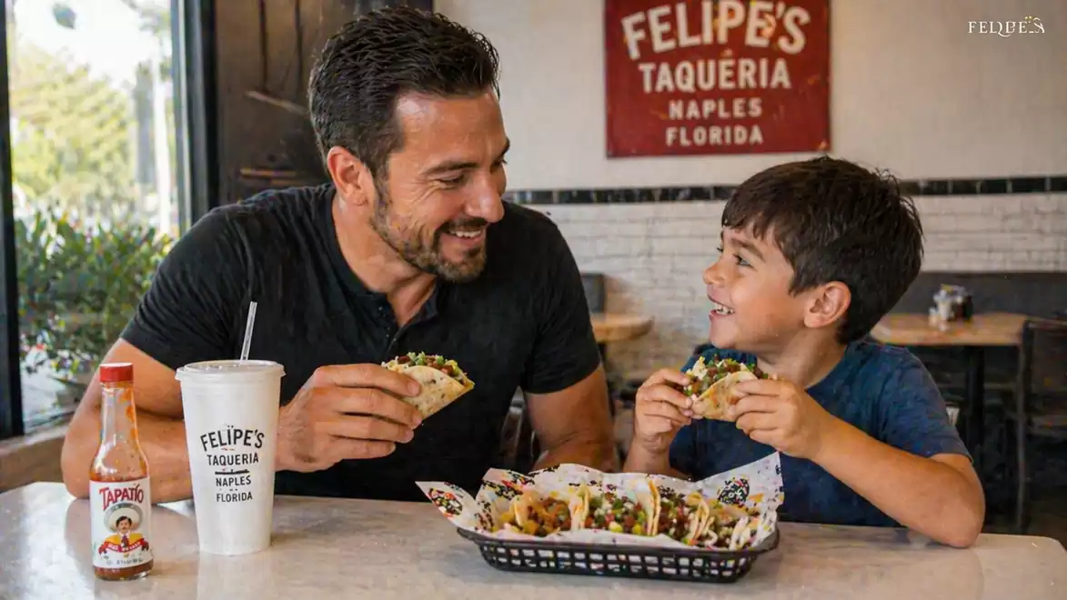 A man and a boy enjoying tacos together at a Mexican restaurant named Felipe's Taqueria in Florida.