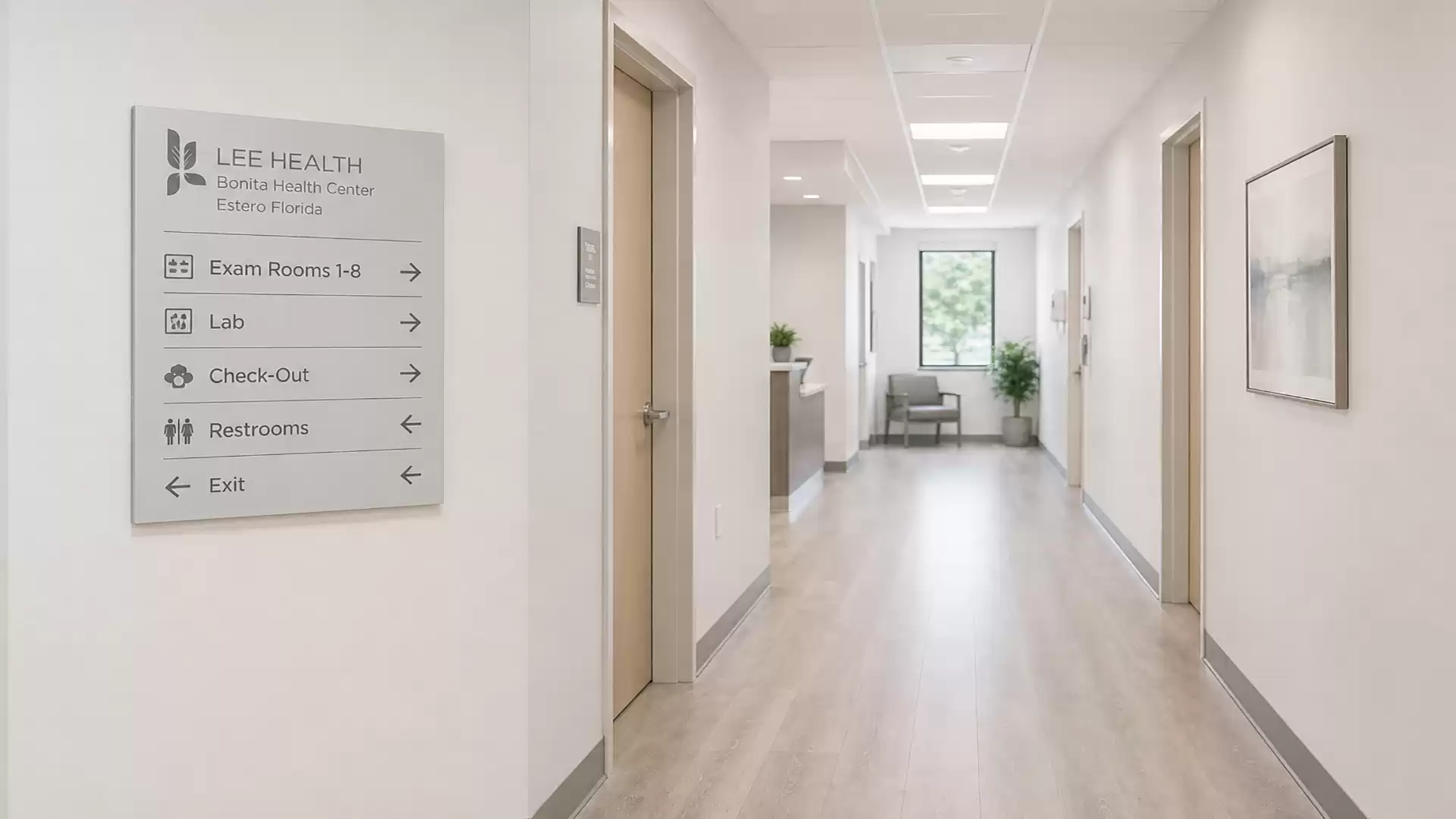 Modern doctor's office with a bright corridor view, left wall has signage to various rooms like labs, restrooms, and check-out.