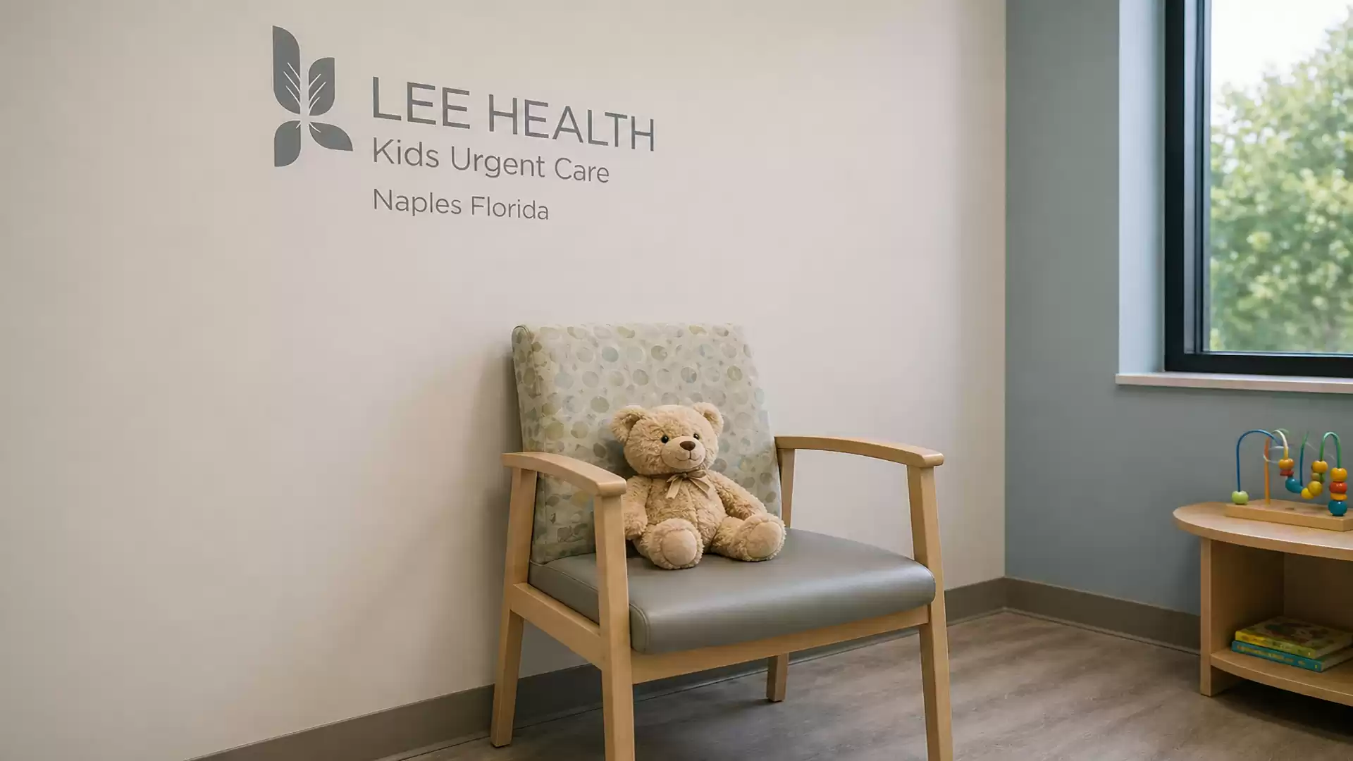 A children's waiting room in a clinic with a plush bear on a chair and a toy table.