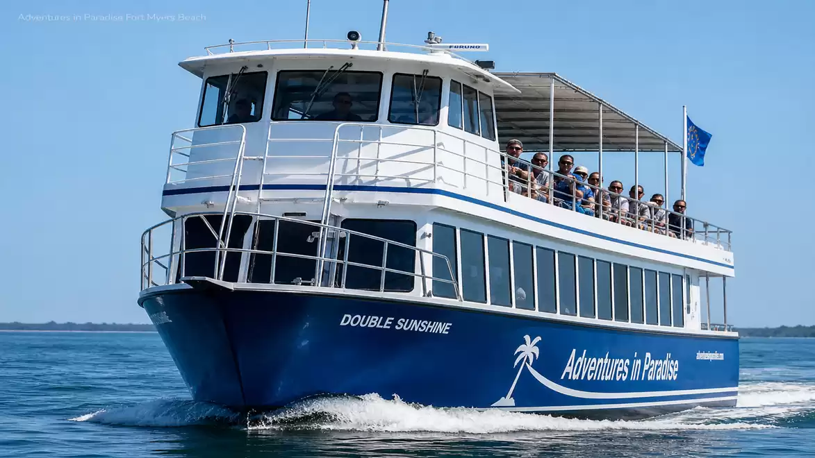 A blue and white excursion boat named 'Double Sunshine' with passengers on board, sailing on open water under a blue sky.