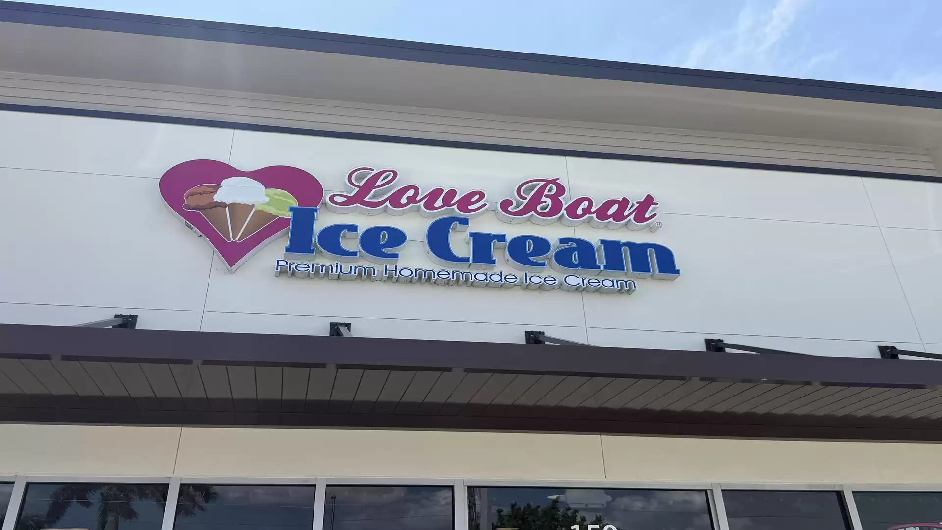 Exterior view of a building with the sign 'Love Boat Ice Cream'.