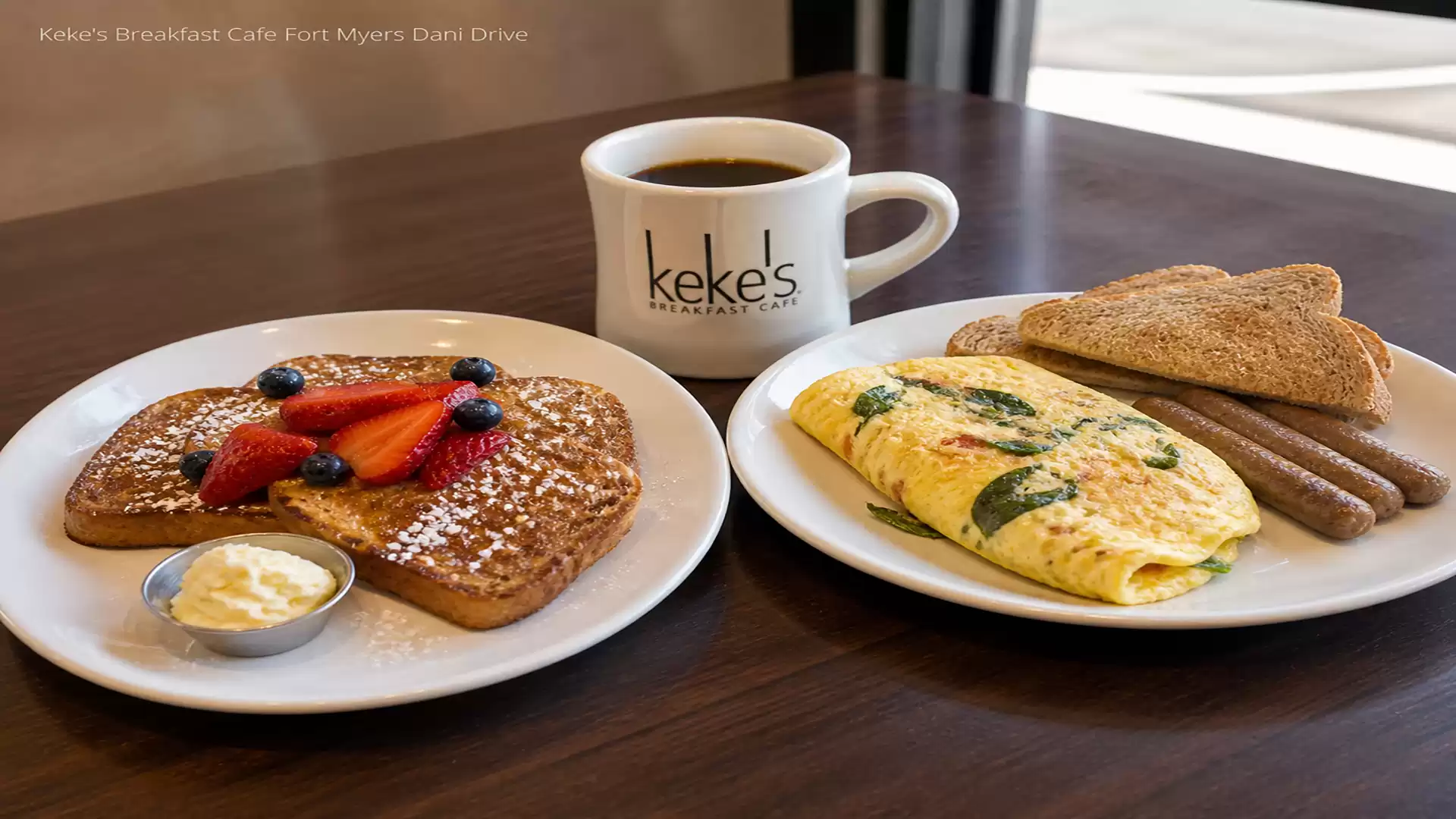 Breakfast table with French toast, omelette, toast, coffee, and sausage at Keke's Breakfast Cafe.