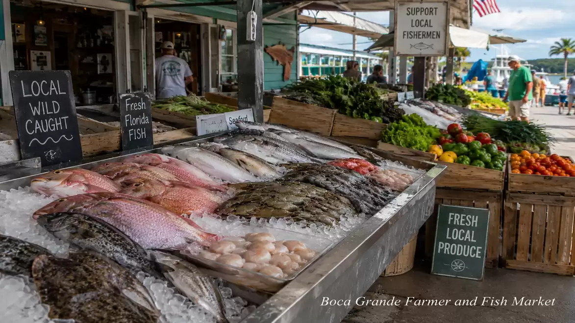Fish and vegetable stand at Boca Grande Farmer and Fish Market with locally caught fresh fish and colorful vegetables.