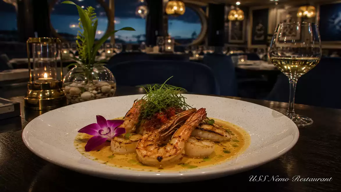 Gourmet dish with shrimp and sauce, decorated with a flower in an elegant restaurant.