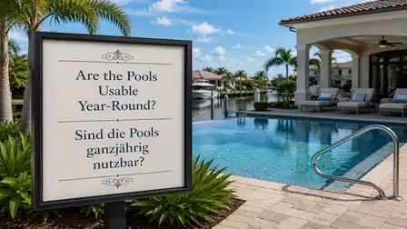 A luxurious pool area with a sign asking in English and German if the pools are usable year-round. In the background are lounge chairs, palm trees, and a tranquil waterway.