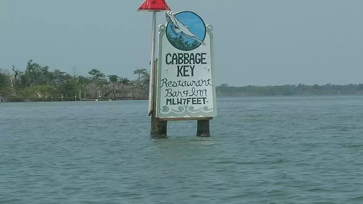 A sign in the water indicates the Cabbage Key Restaurant, mentioning a bar and inn with a depth indication of MLW 17 FEET.