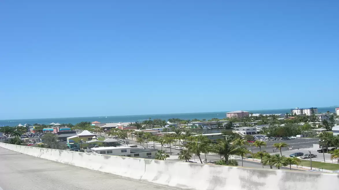 Coastal city with blue sky and sea in the background.