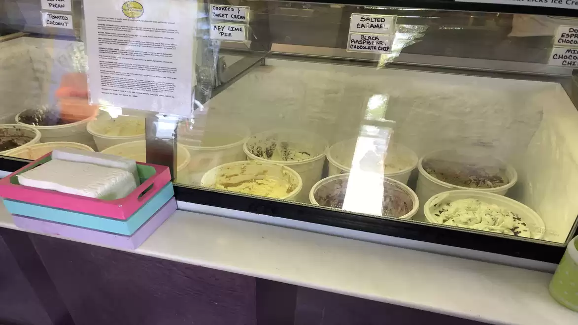 Ice cream selection in a shop with various flavors in freezer containers.