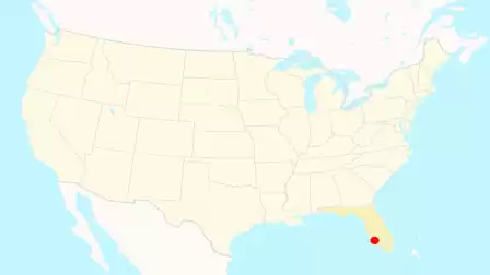 Map of the USA highlighting the state of Florida in yellow with a red dot marking a specific location.