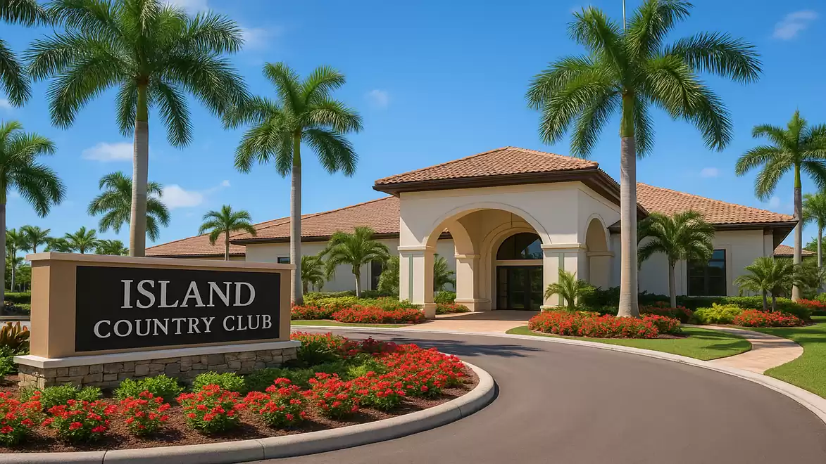 Entrance to Island Country Club with palm trees and well-kept gardens under a blue sky.