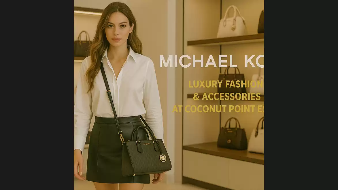 Woman in fashion store wearing elegant white blouse and black skirt, accompanied by a black handbag. Shelves with luxury bags are visible in the background. Michael Kors advertisement.