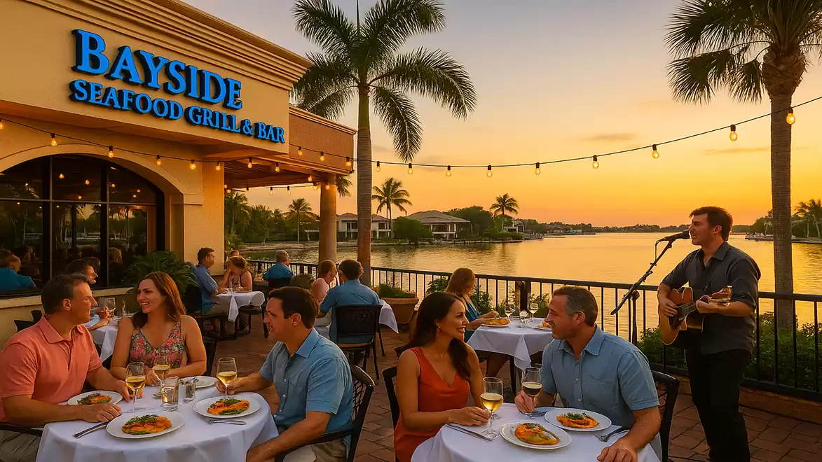 Outdoor dining at a waterfront restaurant during sunset, with live music and guests enjoying their time.