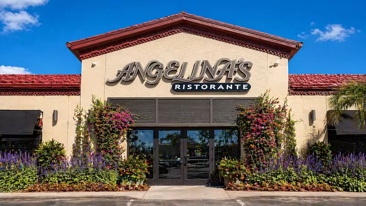 Exterior view of an Italian restaurant called Angelina's Ristorante with colorful flowers and blue sky