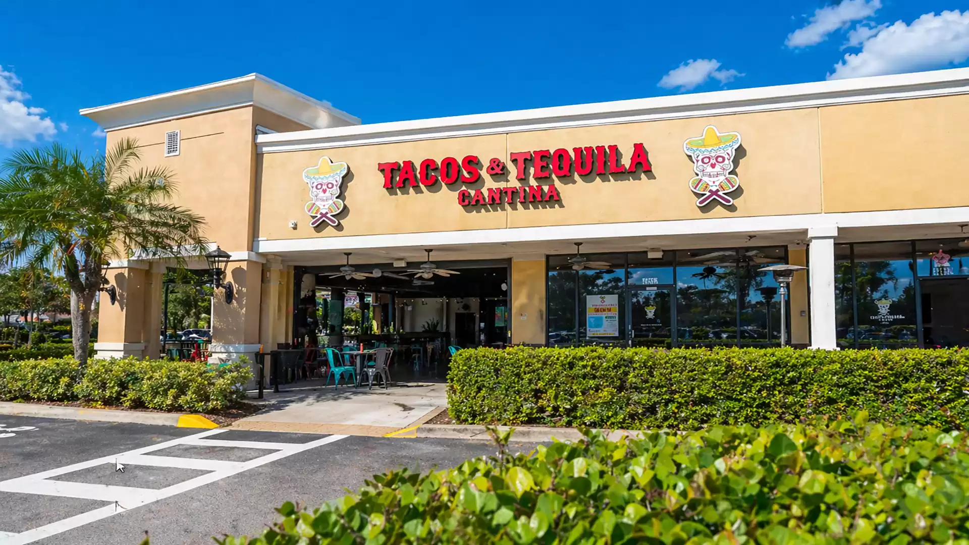 Exterior view of a Mexican restaurant named Tacos & Tequila Cantina on a sunny day.
