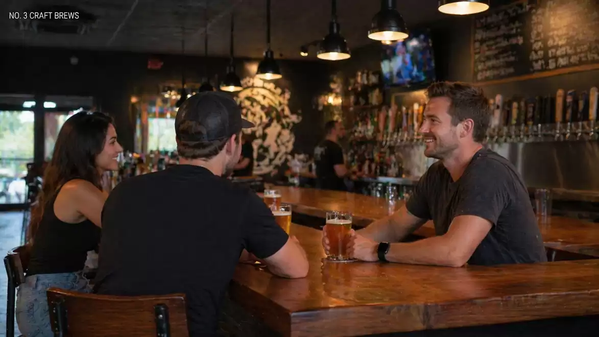 Three friends in a cozy bar, drinking beer and laughing. In the background, beer taps and a menu board are visible.