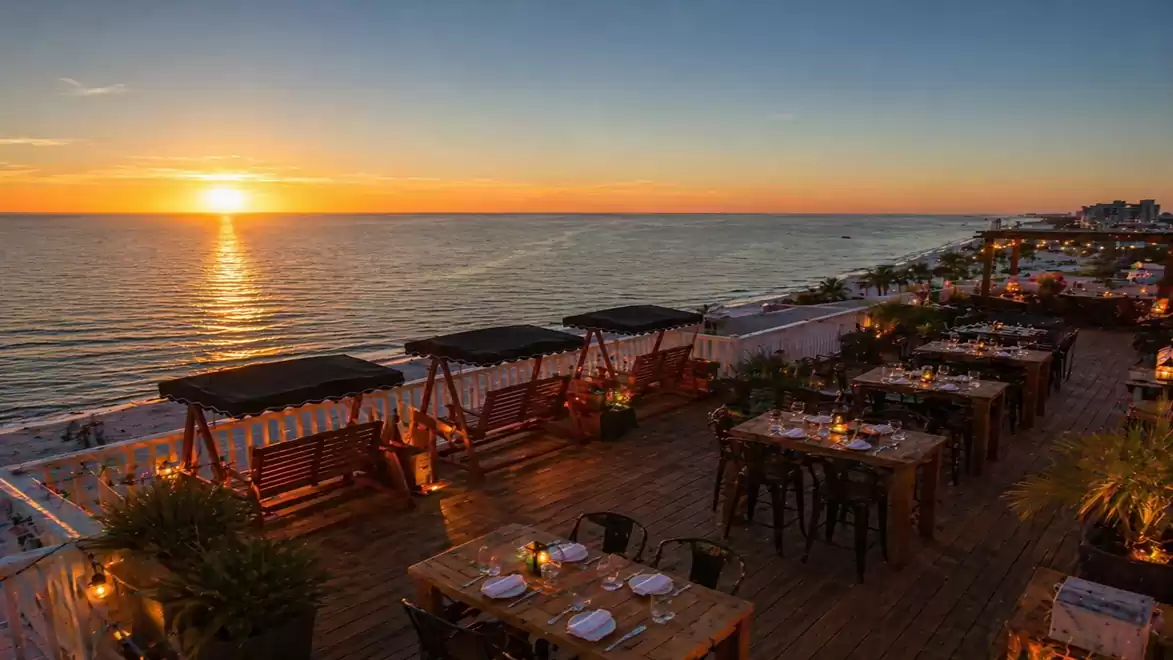 Romantic dinner on a terrace with sea view and breathtaking sunset.