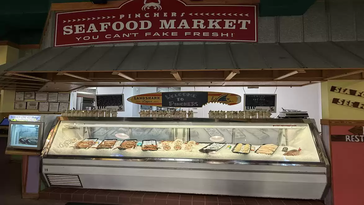 Fresh fish and seafood at the counter of a seafood market.