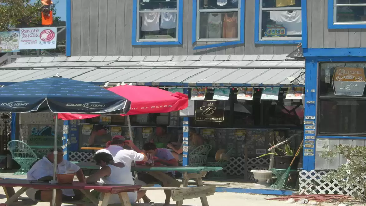 A cozy café with colorful umbrellas and outdoor tables, providing a relaxing atmosphere.