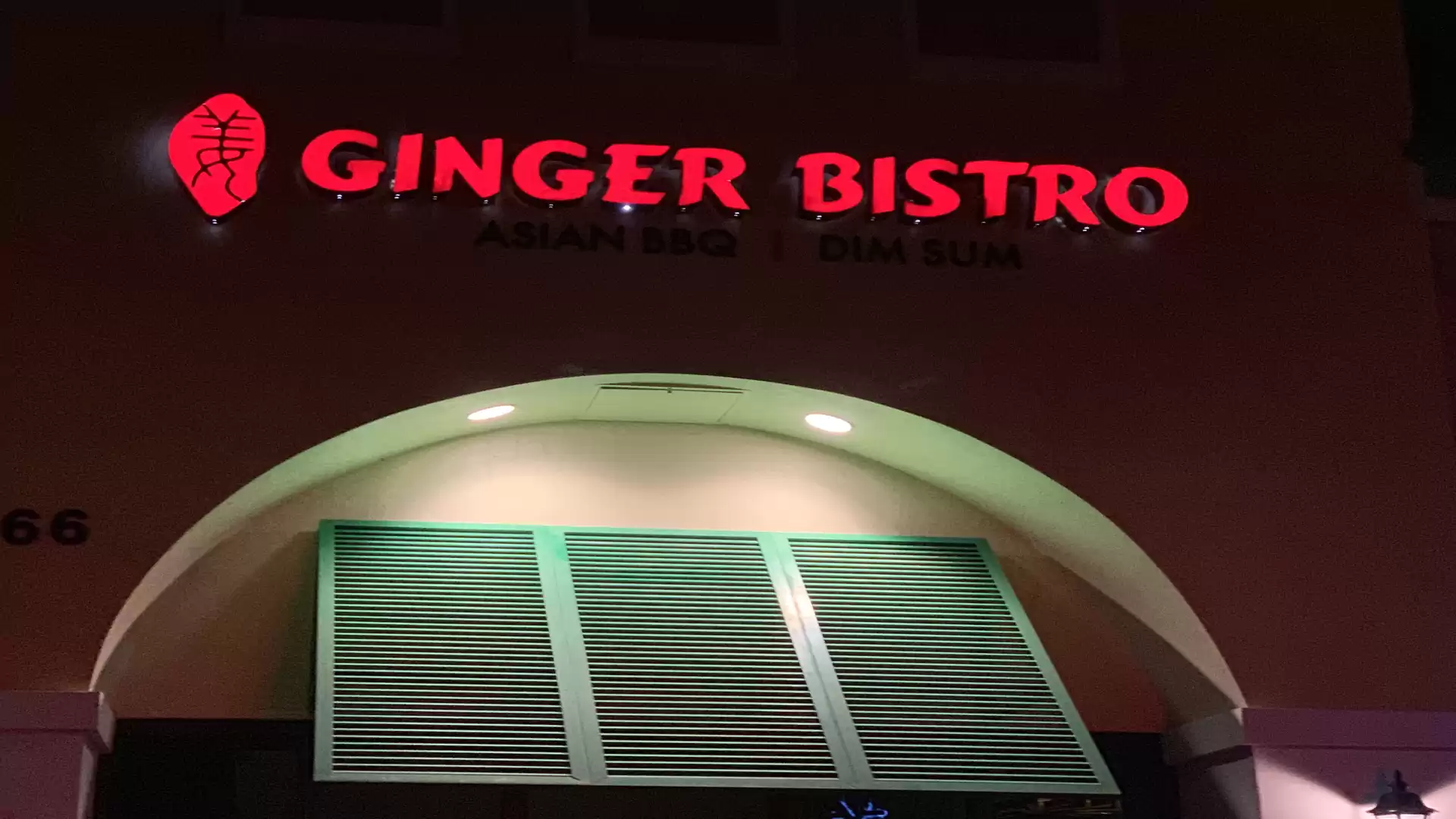 Exterior view of Ginger Bistro restaurant with illuminated red sign.