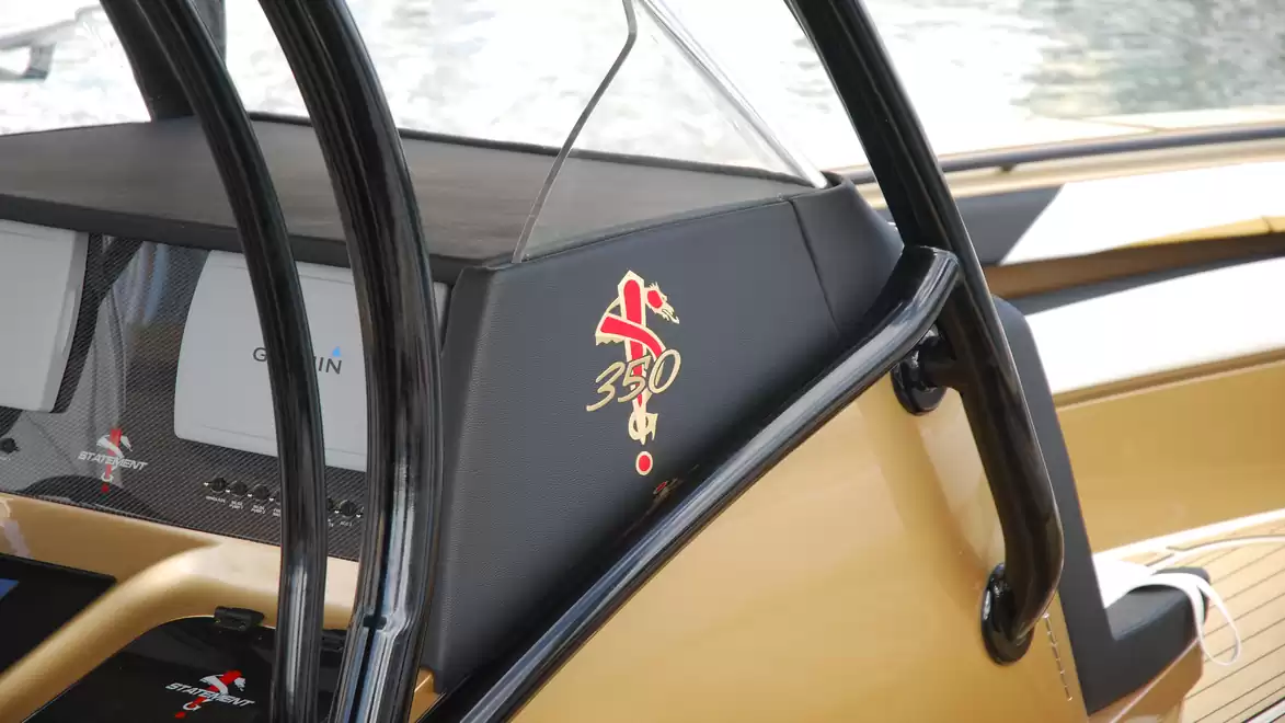 Interior view of a modern boat with a digital dashboard and stylish design.